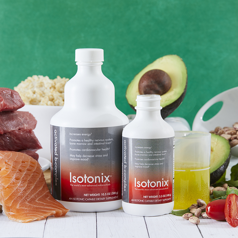 Isotonix Activated B Complex, two different size bottles, with liquid serving cup partially filled, surrounded by fresh salmon, beef and avocado
