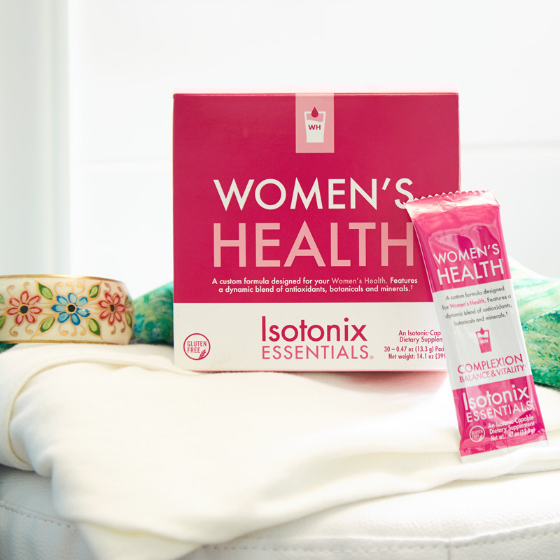 Isotonix Essentials Women's Health Product showing packet size on a blouse and a bracelet to the left