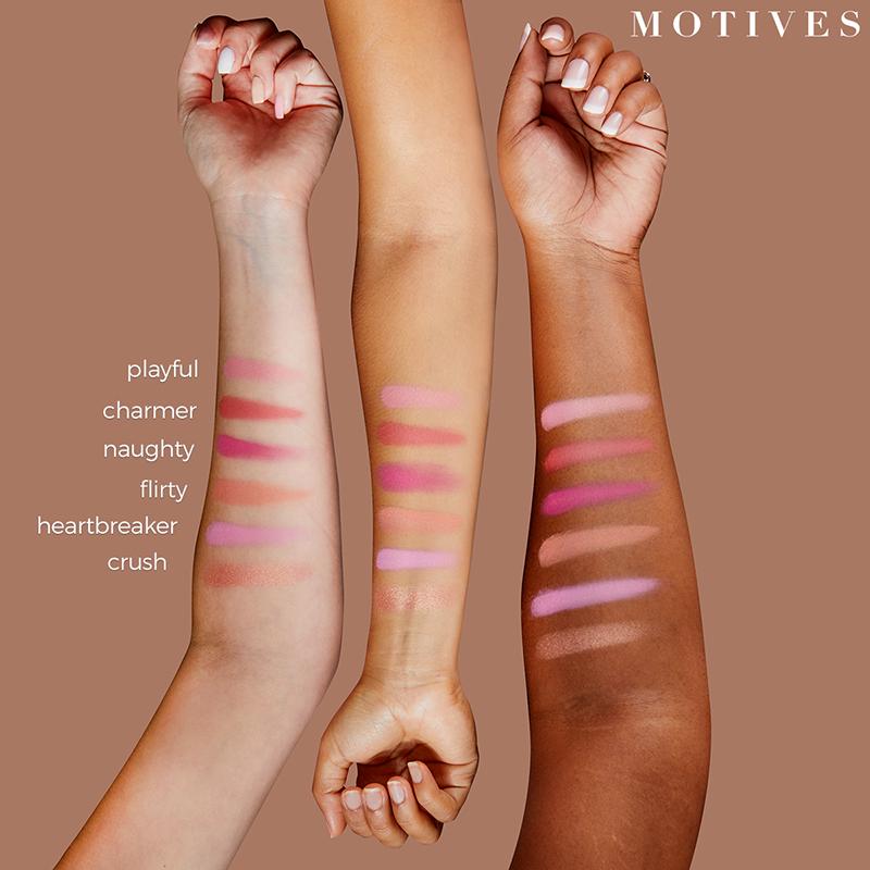 Motives Get Cheeky Blush Palette, shown as stripes of colors on three models' arms of light, medium and dark skin tones 