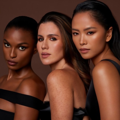 3 models of different skin tones wearing Motives X Amber Essential Collection.