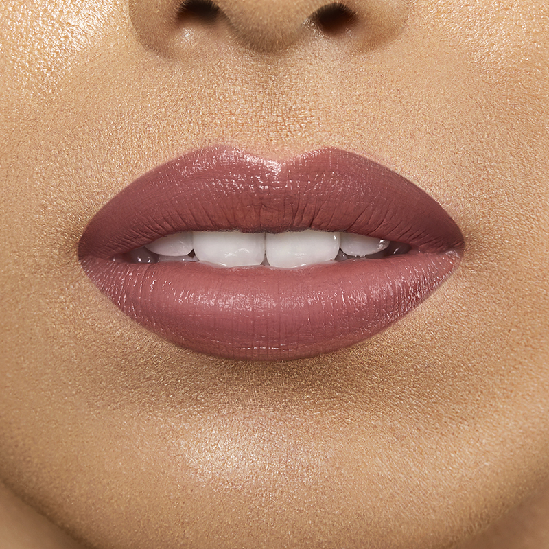 Closeup on lips of model with light skin tone wearing Motives Liquid Lipstick, color Savage