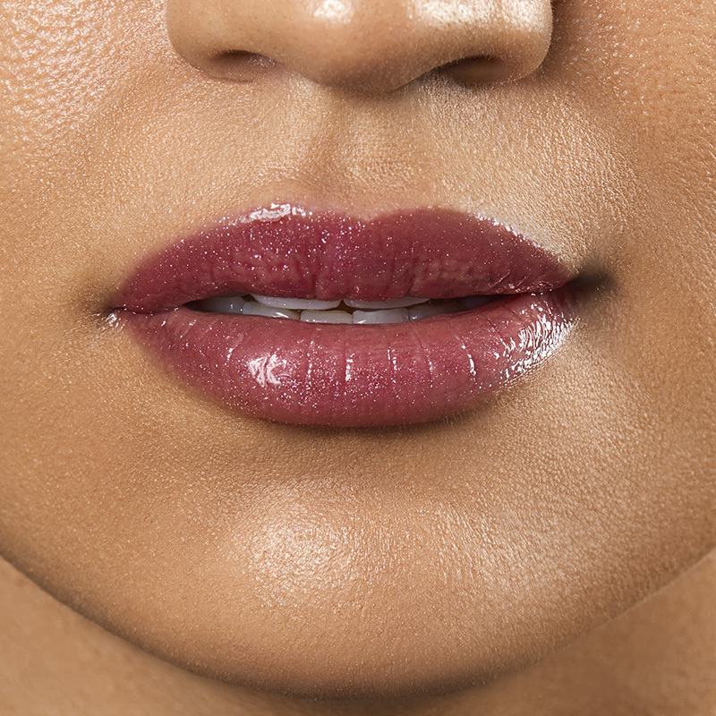 Motives Liquid Lip Glaze, color Sweets, closeup on lips of model with medium skin tone