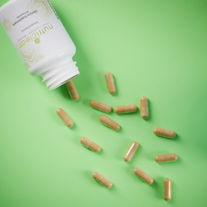 NutriClean HepatoCleanse (Liver Support Formula), caplets poured on a green table to view