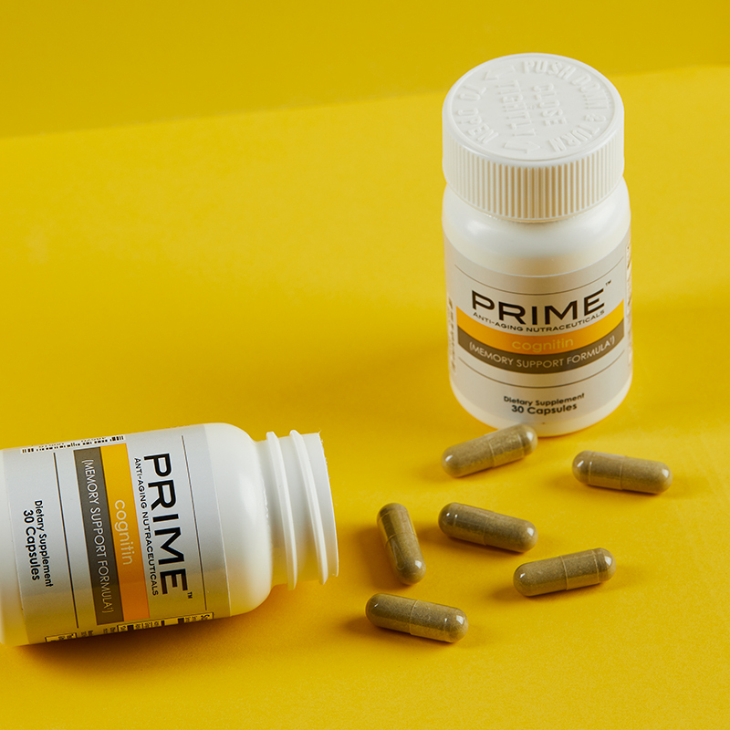 Prime Cognitin Memory Support Formula, with caplets spilling out onto yellow table