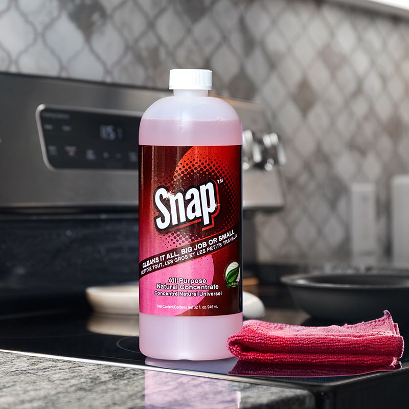 Snap All-Purpose Natural Concentrate, shown on stovetop with folded towel