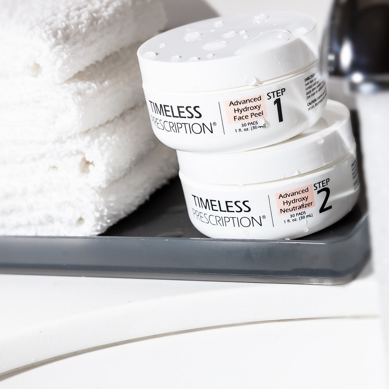 Timeless Prescription Advanced Hydroxy Face Peel and Neutralizer, on a shelf next to wash cloths