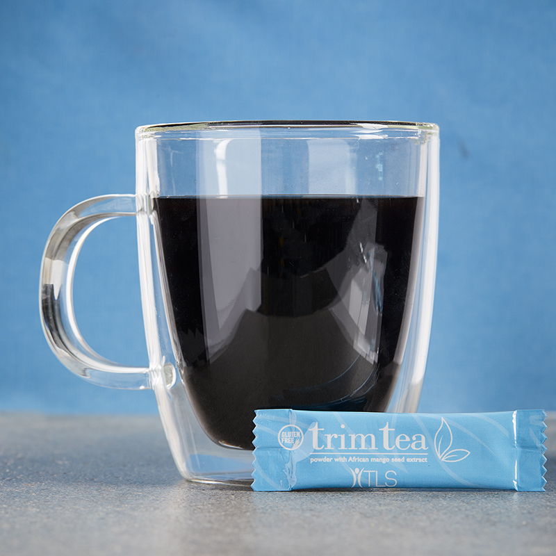 TLS Trim Tea packet next to a mug of mixed Trim Tea