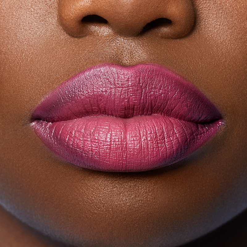 Closeup on lips of model with dark skin tone wearing Motives Lip Kit, color Like Really Pretty
