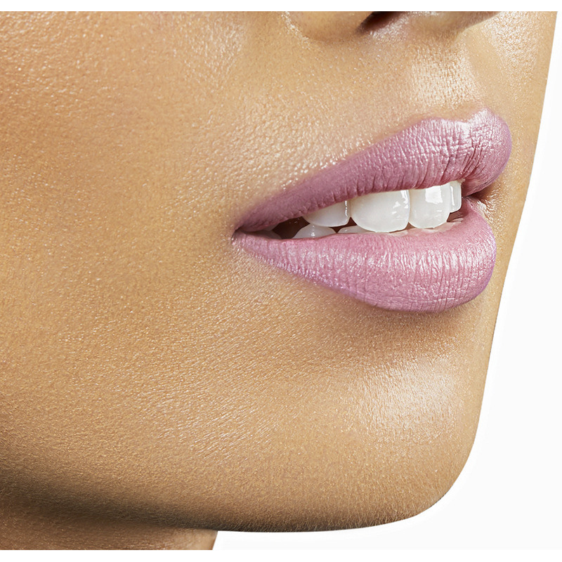 Closeup on lips of model with medium skin tone wearing Motives Cream Lipstick, color Cupcake, side view