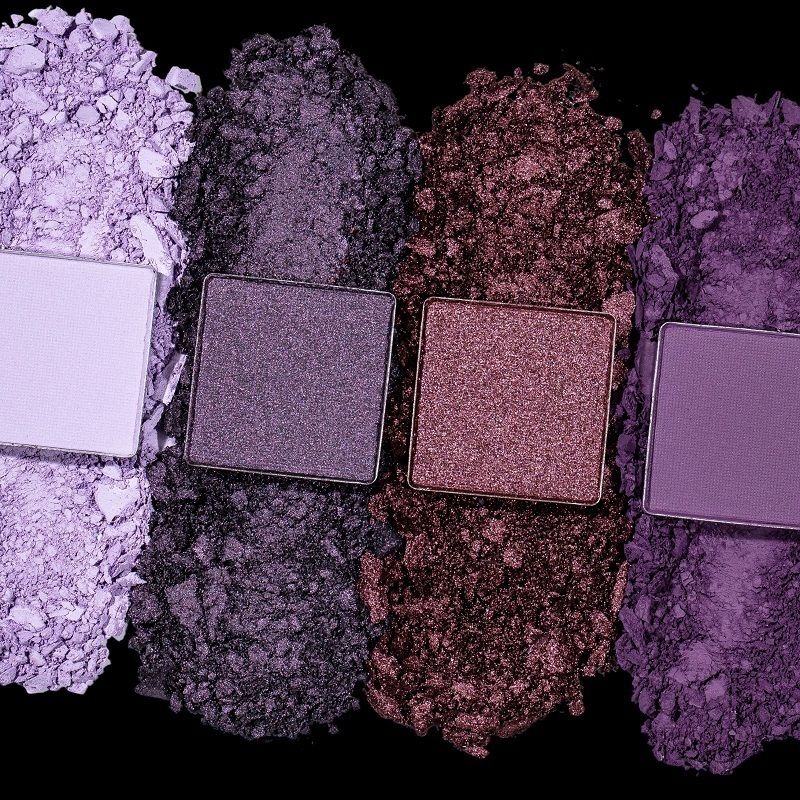 Up close view of THALIA X Motives Besos Palette eye shadow colors, a lavender, dark purple, mauve and vibrant purple 