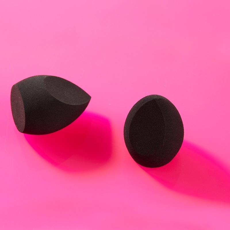 Two black Motives Blending Sponges on a pink surface