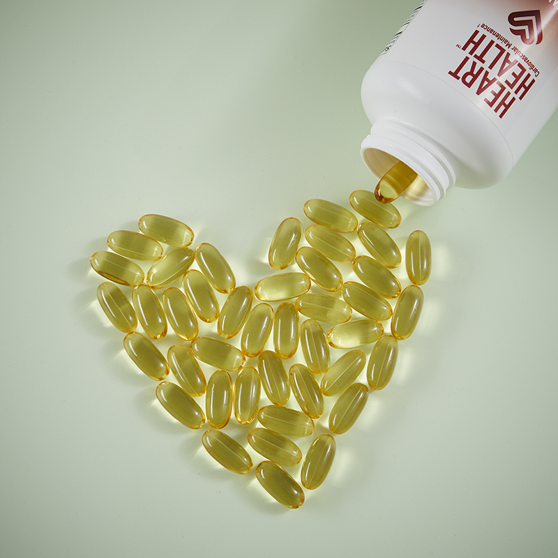 Heart Health Essential Omega III Fish Oil with Vitamin E, caplets in the shape of a heart on a table