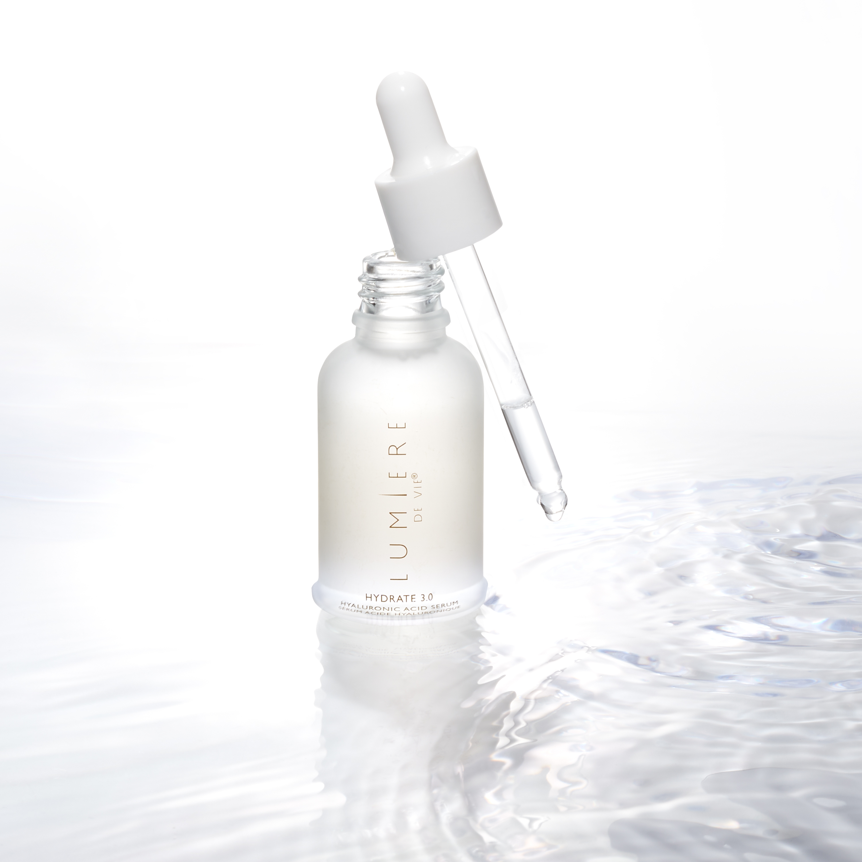Lumiere de Vie Hydrate 3.0 with dropper angled over the side in a pool of serum.