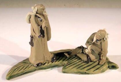 Bonsai Boy e3442 3 in. Miniature Ceramic Figurine - Two Mud Men On A Leaf, One Standing Holding A Bag & The Other Sitting Smoking A Pipe 