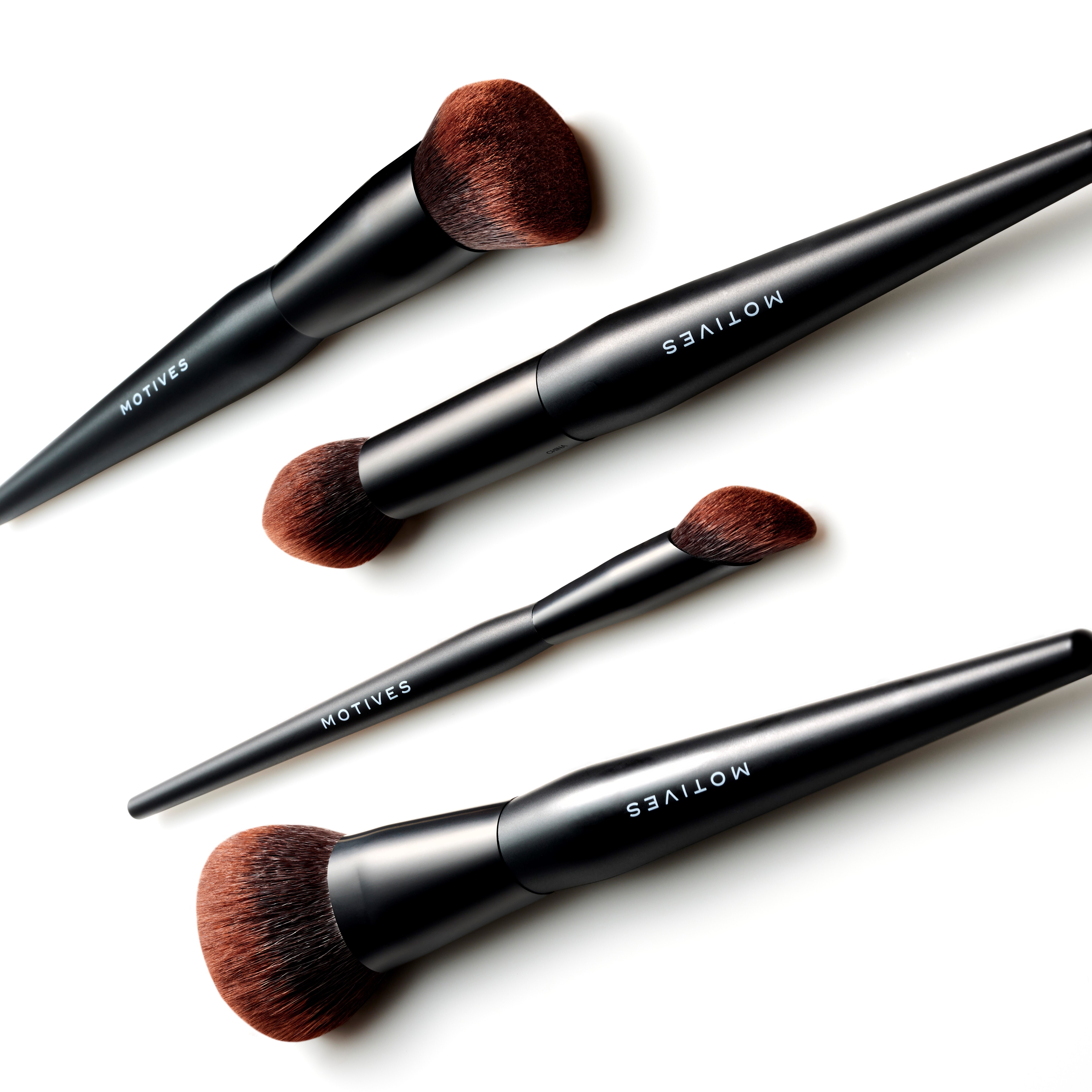 All 4 brushes from Motives Essential Complexion 4-Piece Brush Set displayed on white background.