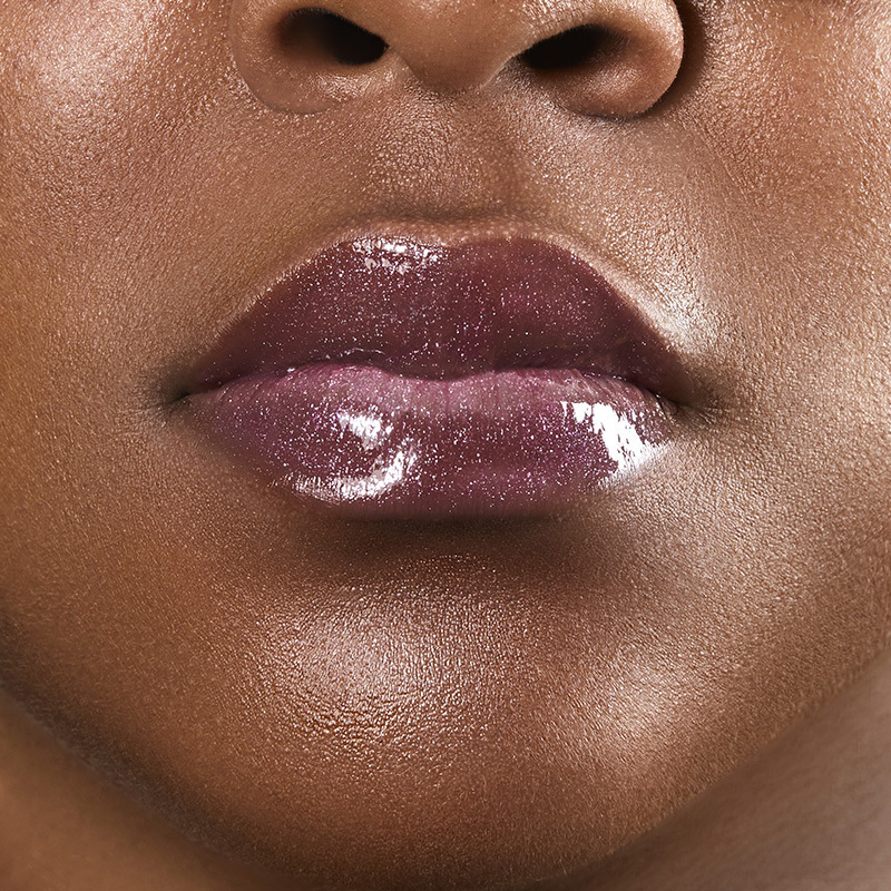Motives Liquid Lip Glaze, color Sweets, closeup on lips of model with dark skin tone