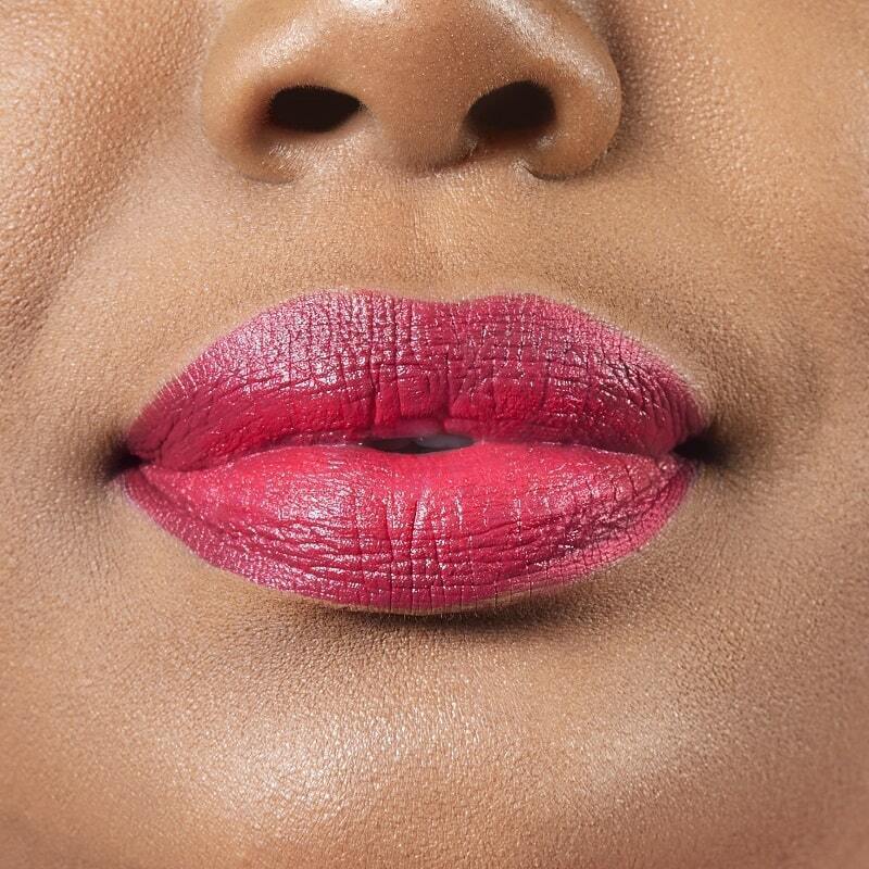 Closeup on lips of model with dark skin tone wearing Motives Lip Kit, color Déjà Vu