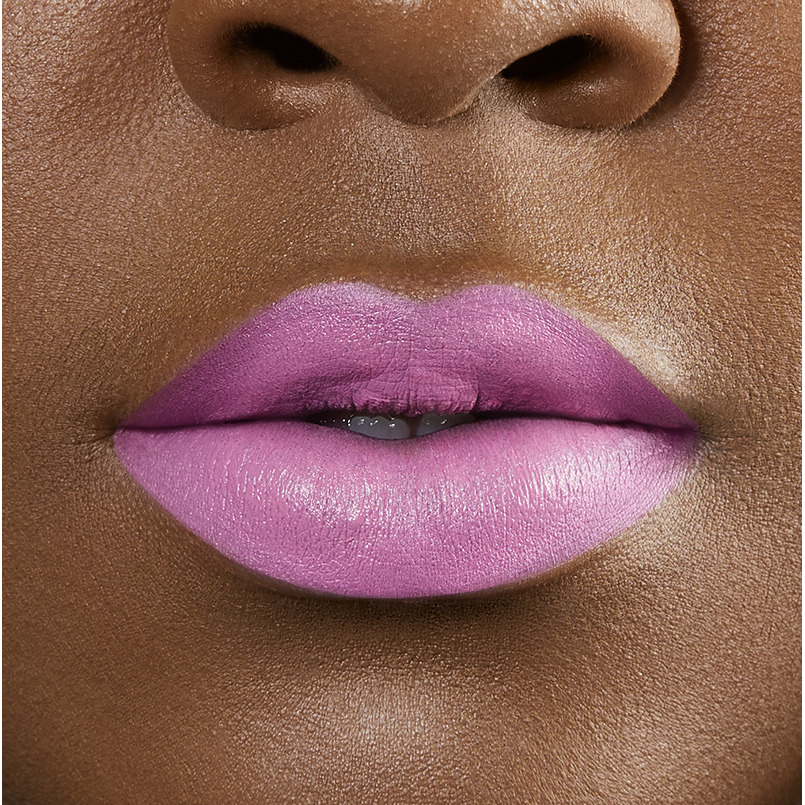 Closeup on lips of model with dark skin tone wearing Motives Cream Lipstick, color Baddie