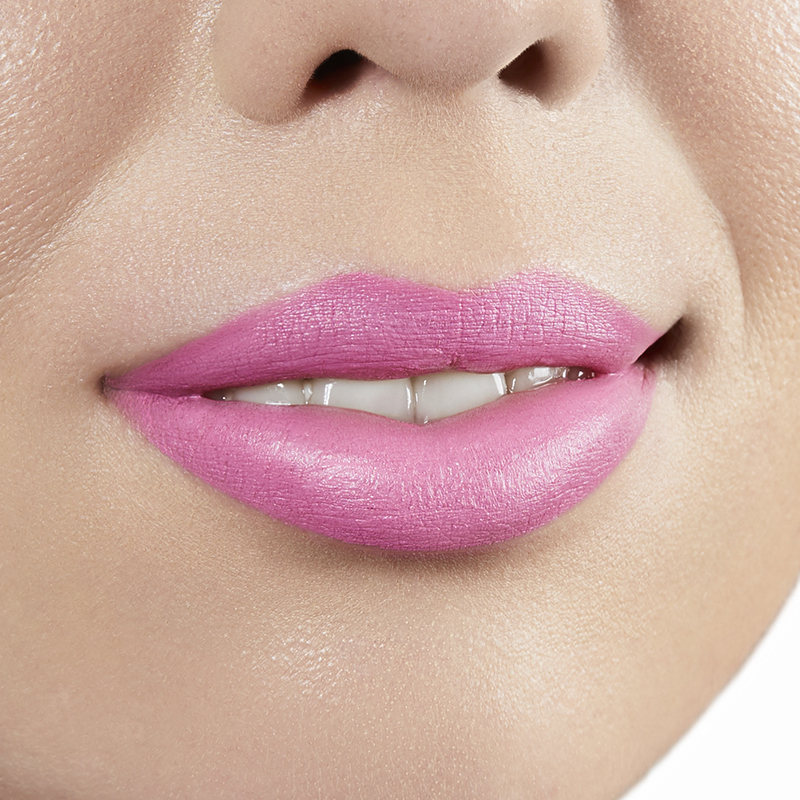 Closeup on lips of model with light skin tone wearing Motives Cream Lipstick, color Baddie