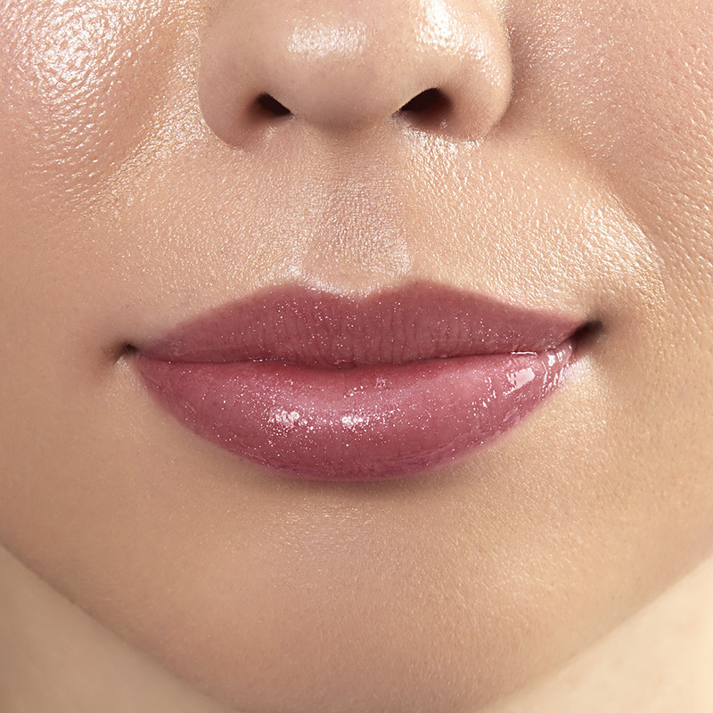 Motives Liquid Lip Glaze, color Sweets, closeup on lips of model with light skin tone