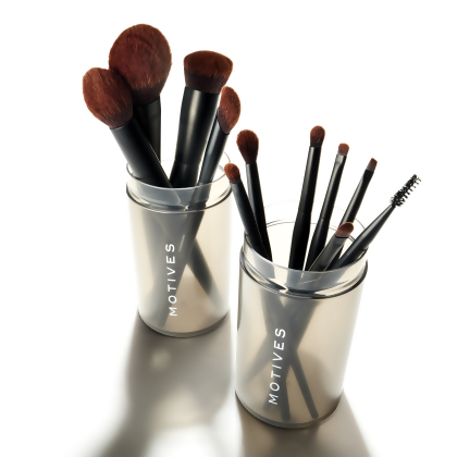 Motives Essential Brush Sets displayed in their storage cases.