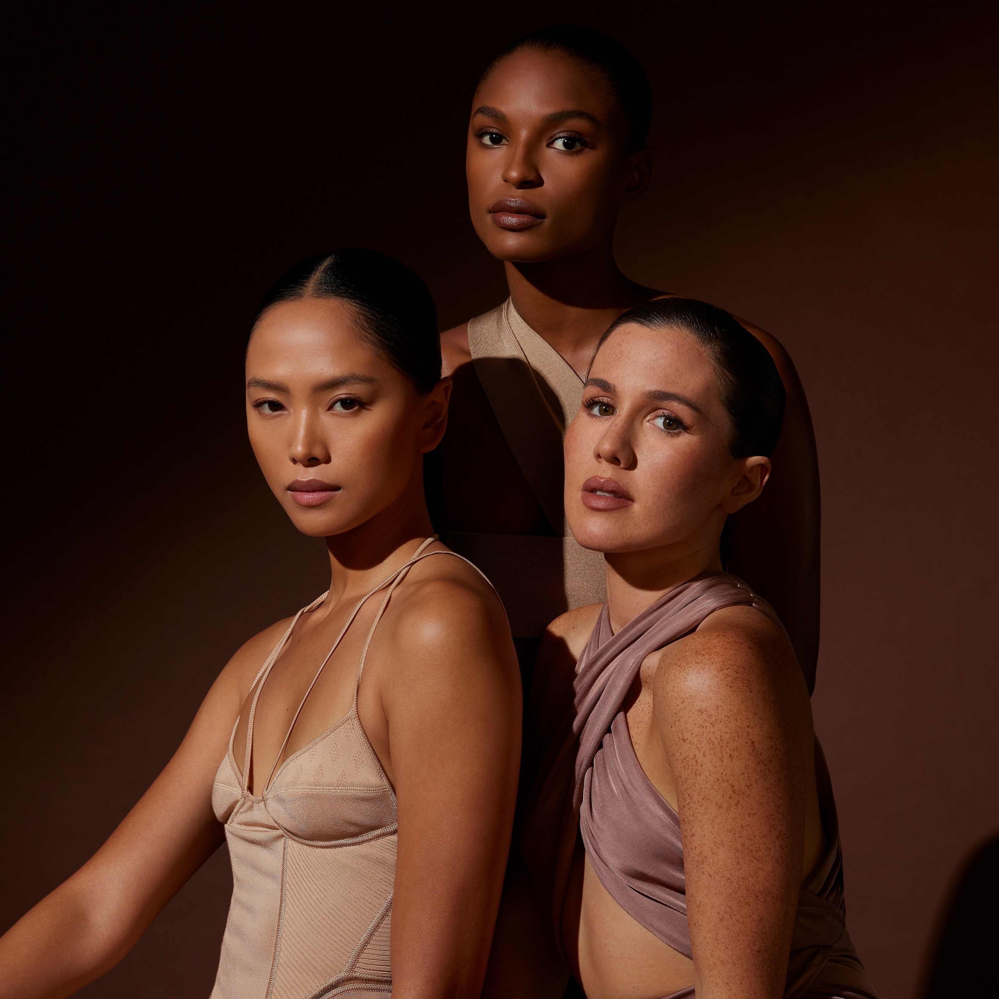 3 female models wearing the Motives X Amber Essential Collection.