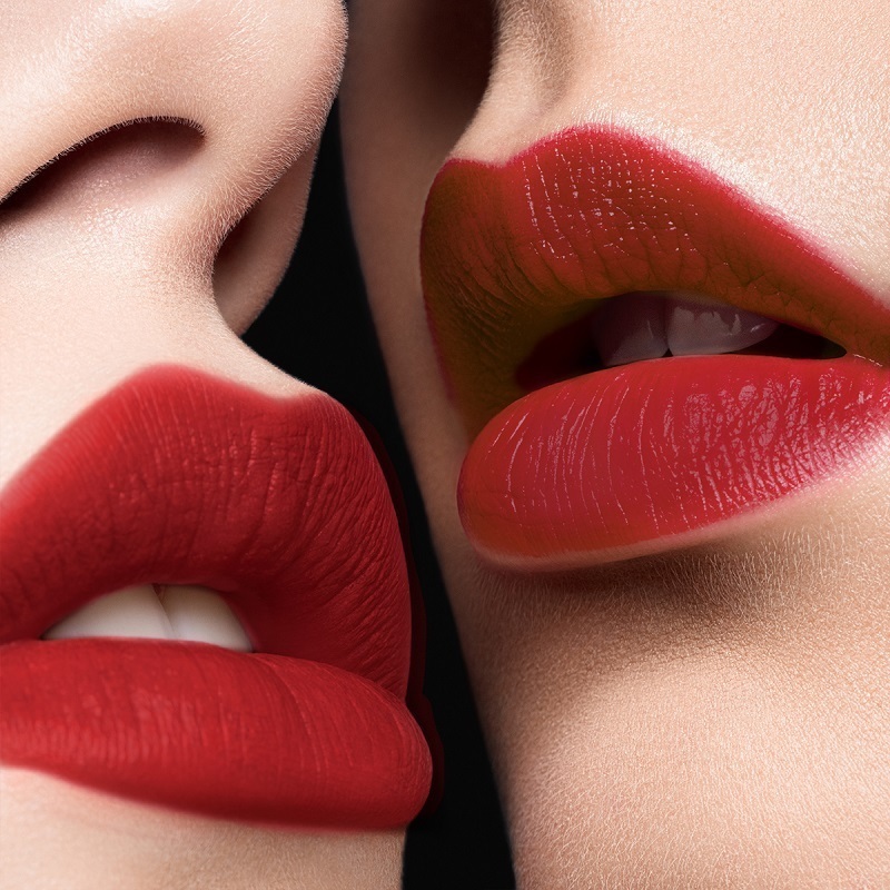 Closeup of two sets of womens lips wearing THALIA X Motives Liquid Lipstick in Red Velvet