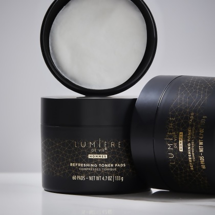 Lumière de Vie Hommes Refreshing Toner Pads jars, one open showing white pads inside