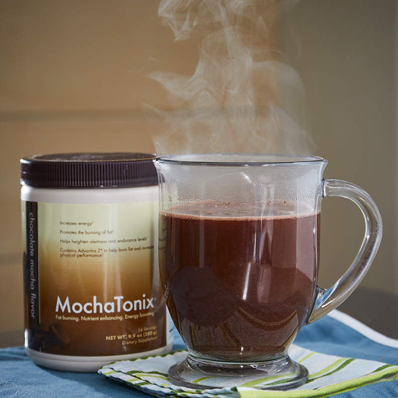 MochaTonix Single Canister Chocolate Mocha Flavor, with hot MochaTonix in a glass mug on a folded towel