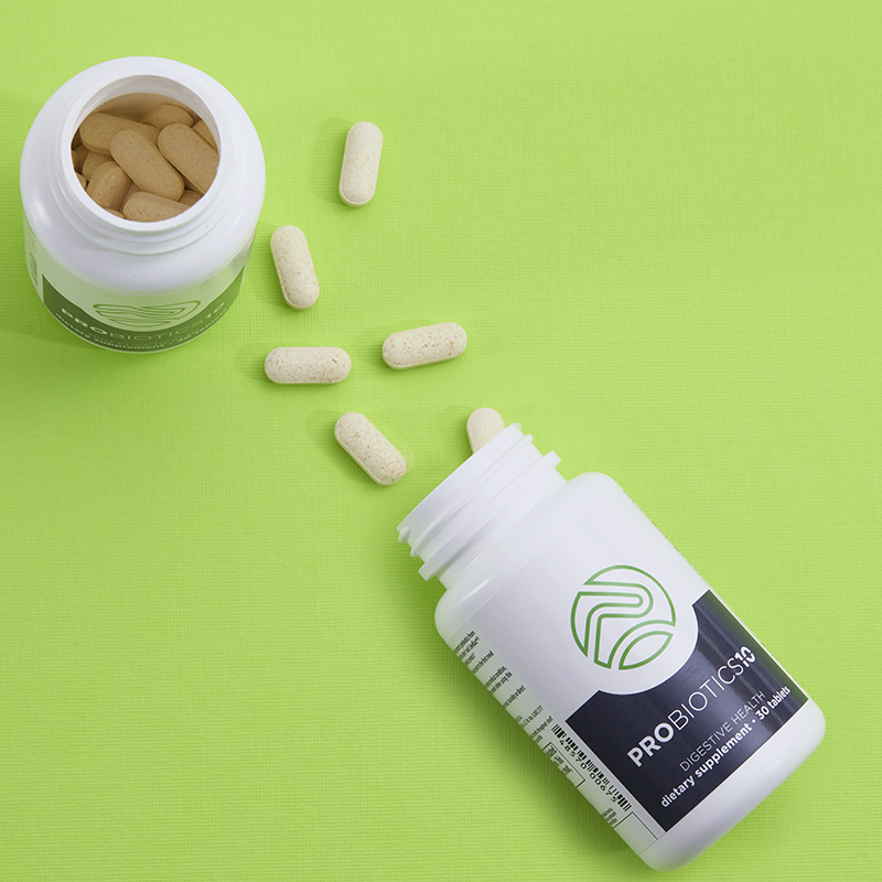 Probiotics-10, open product showing caplets spilled onto a green table