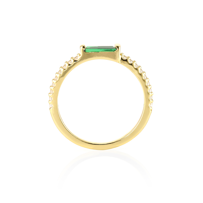 Closeup of gold Zoe - Tapered Baguette Pave Ring, gold with green gem