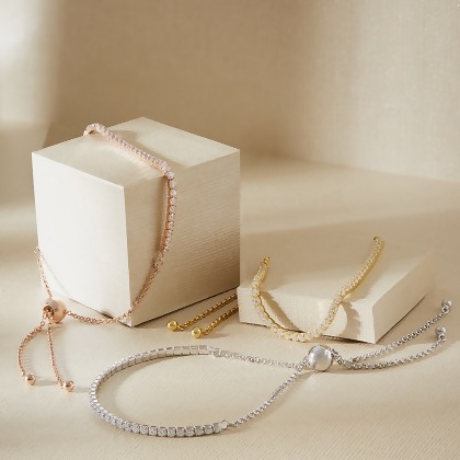 Three Layered Violet - Round Cut Tennis Bracelethown in Rose Gold, Gold, and silver displayed on boxes