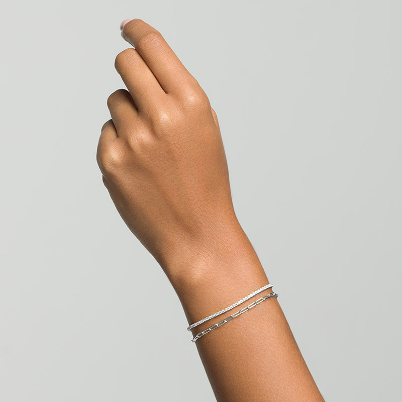 Woman's arm showing Layered ARIA - Multi Use Link and Stone Choker in silver, worn wrapped twice as double-bracelet, two looks in one