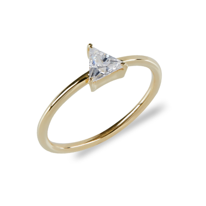 Closeup of Layered Naomi - Sleek Trillion Ring in gold with clear gem, angled view
