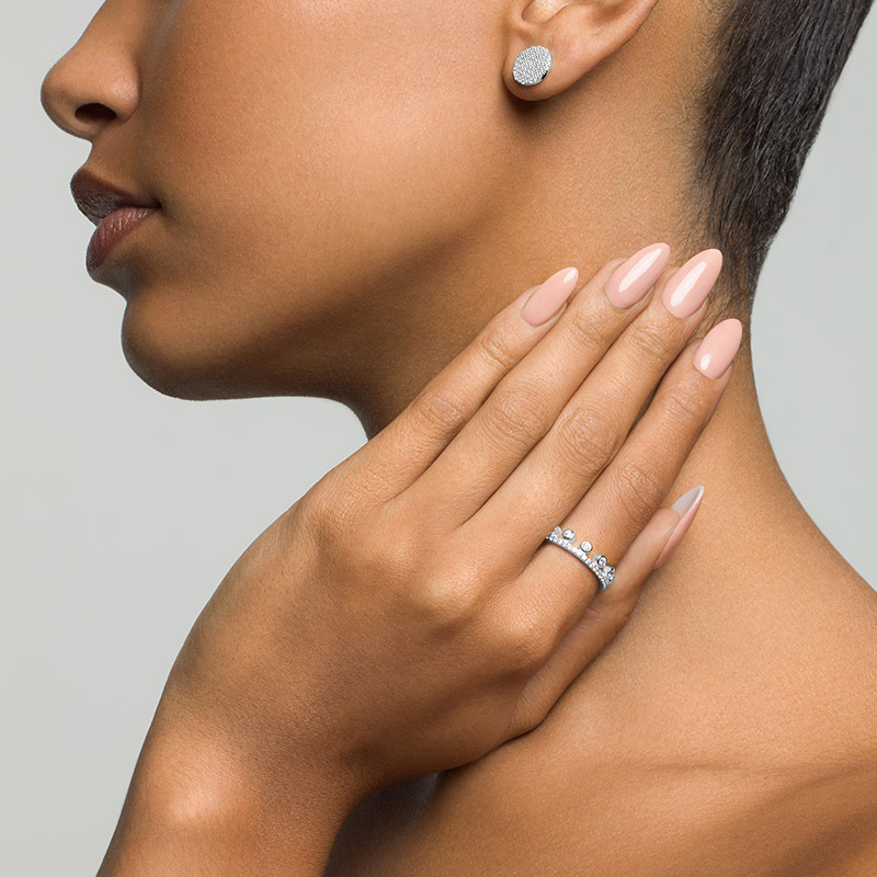 Model wearing PRIYA Crown Ring in silver and Layered JASMINE Pave Studs in silver