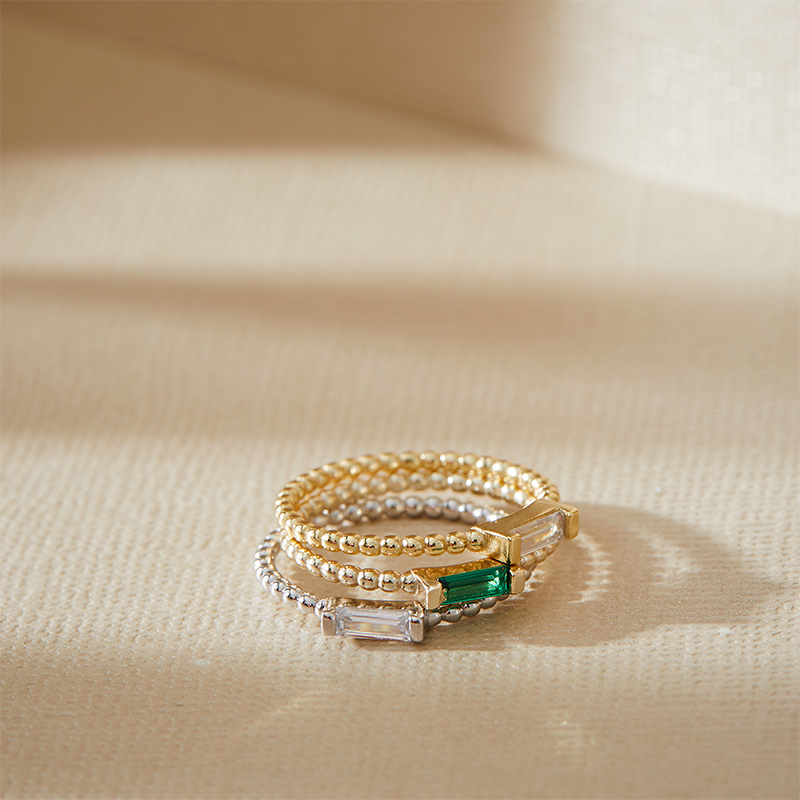 Layered Adrienne - Spiraled Baguette Ring stacked with other rings, in gold