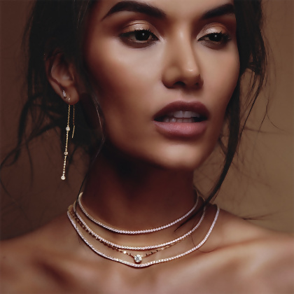 Model wearing Layered AYVA - Round Cut Tennis Chokers, KATIE - Textured Solitaire Necklace, and CARA - Threaded Drop Earrings, in gold