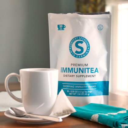 Shopping Annuity Brand Premium ImmuniTea shown with a cup on a napkin with spoon and a blue tea towel