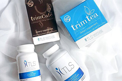 Four different TLS products laid out, TLS® Trim Tea, TLS® Trim Café, TLS® CORE Fat & Carb Inhibitor, TLS® CLA (Conjugated Linoleic Acid).