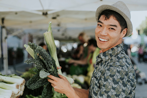 Man holding fresh lettuce at farmers market
