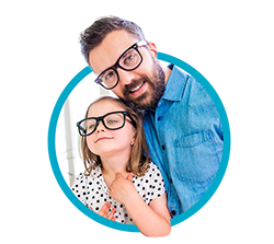 Dad and kid smiling while wearing black framed glasses.
